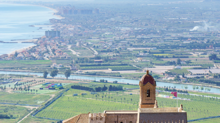 Castle and walls of Cullera Valencia Spain in the background Ribera Baixa landscape.