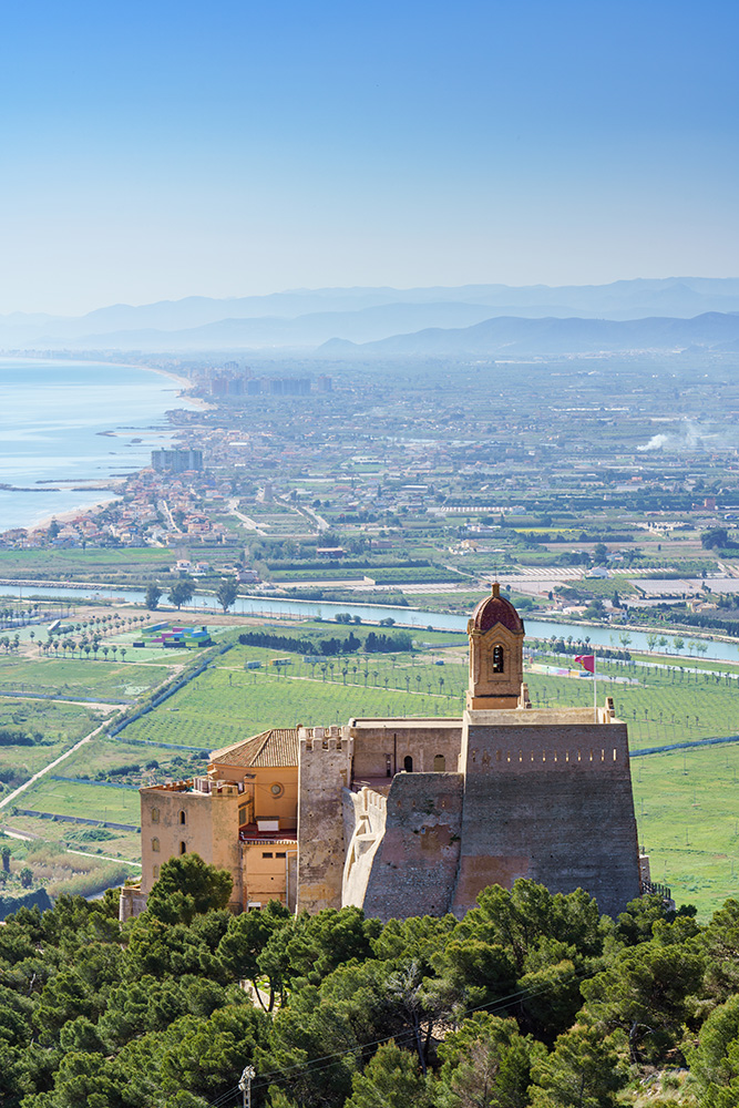 Castle and walls of Cullera Valencia Spain in the background Ribera Baixa landscape.
